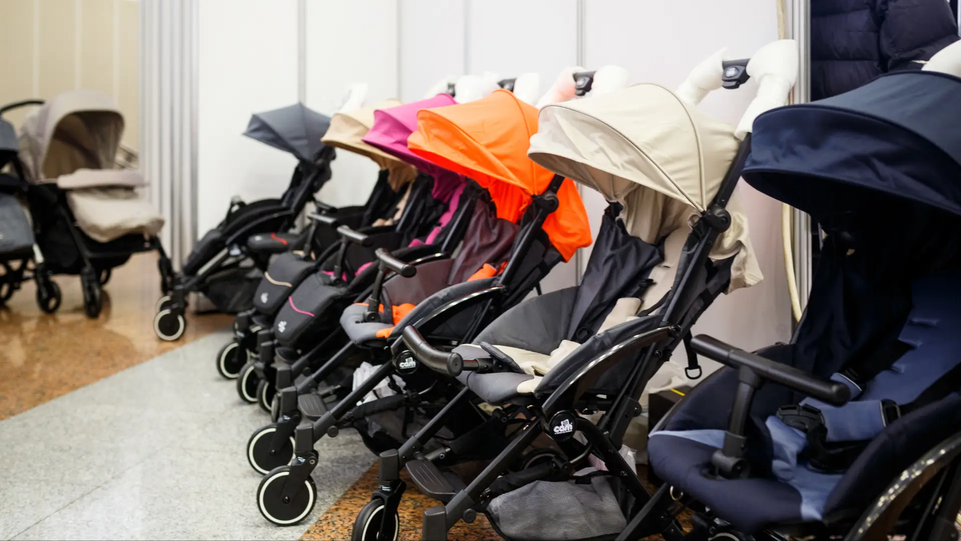 A selection of prams on display inside a retail space