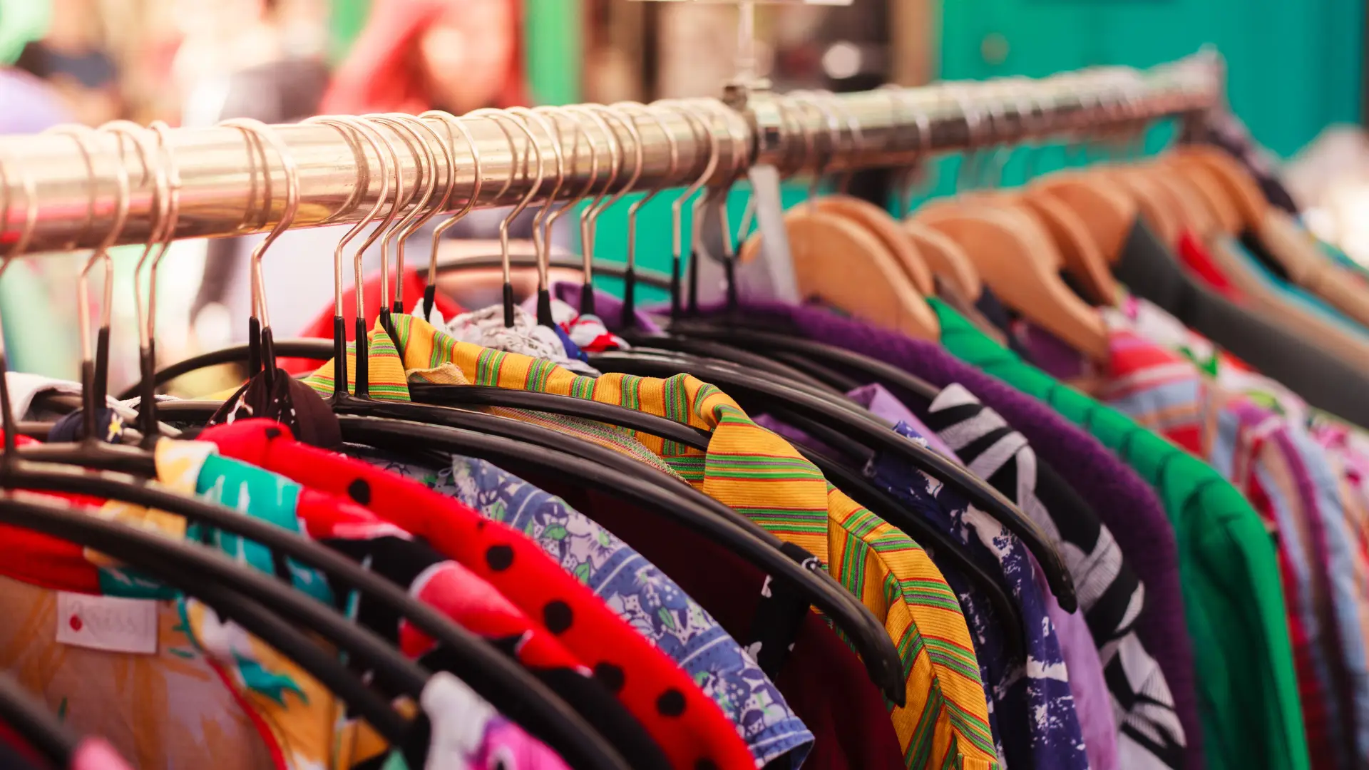 Close-up of brightly coloured clothing on a rack