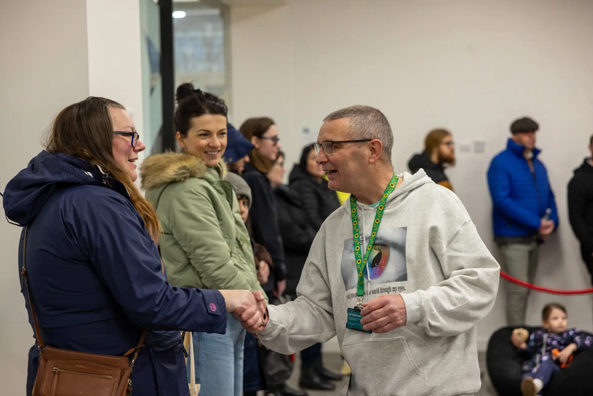 Autism activist Arsenal Whittick shaking hands with a volunteer at his world record attempt event