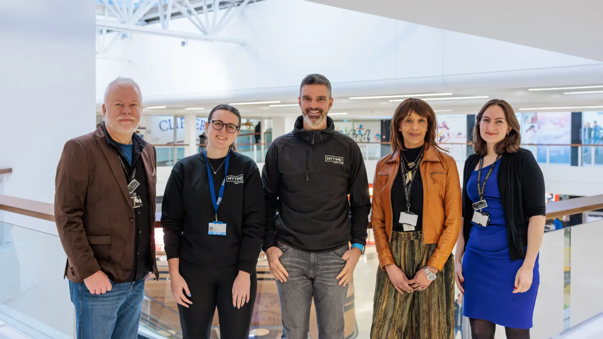 Members of The Dolphin team stand with members of MYTime Young Carers team on the balcony of The Dolphin