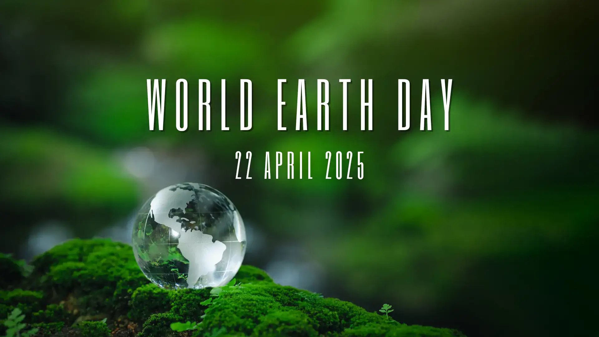 A glass globe with a map of the earth depicted in frosted glass sits on a bed of moss. Above the glass globe the text reads: World Earth Day, 22 April 2025